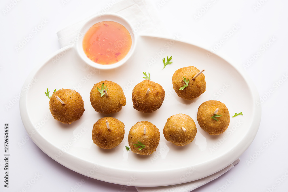 Crispy Veg lollipop recipe made using boiled potato with spices covered with corn flour and bread crumbs coating and then deep fried, served with toothpick or ice cream stock inserted in it with sauce Crispy Veg lollipop recipe made using boiled potato with spices covered with corn flour and bread crumbs coating and then deep fried, served with toothpick or ice cream stock inserted in it with sauce