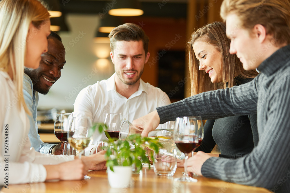 Young people having a glass of wine in a bistro