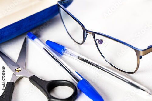 Stationery. Glasses, pens, scissors on white background.