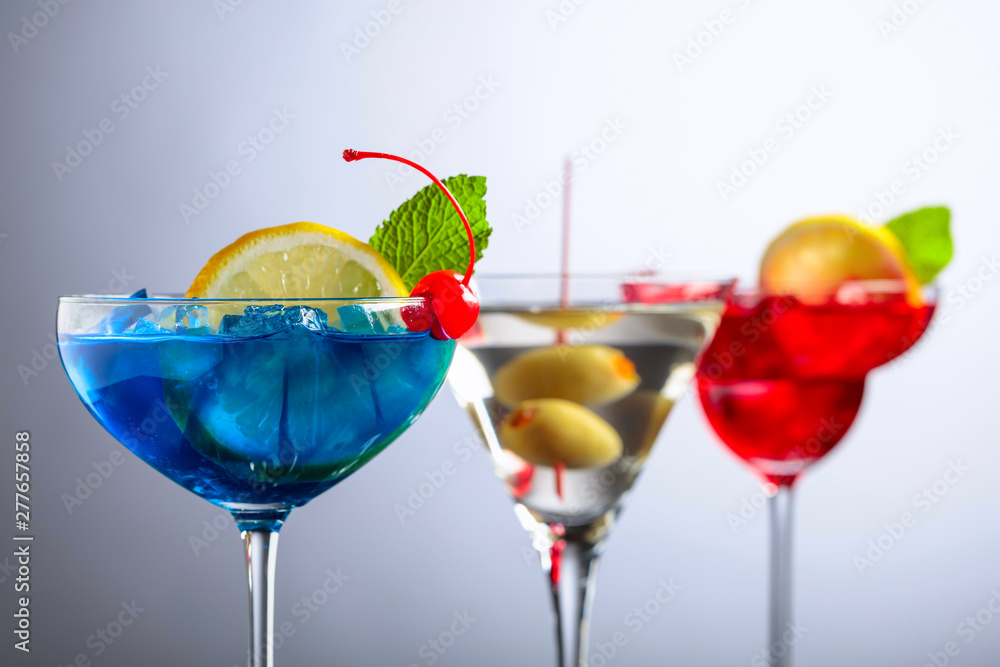 Two colorful cocktails and dry martini with green olives. Two colorful cocktails and dry martini with green olives.