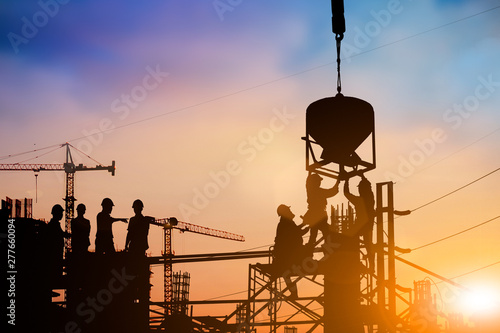 Silhouette of engineer and construction team working at site over blurred background for industry background with Light fair.Create from multiple reference images together