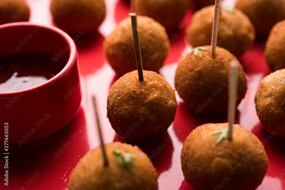 Crispy Veg lollipop recipe made using boiled potato with spices covered with corn flour and bread crumbs coating and then deep fried, served with toothpick or ice cream stock inserted in it with sauce