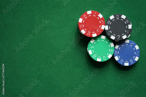 Stacks of gambling/poker chips on green background, casino concept