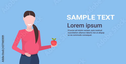 pregnant woman holding apple girl eating fresh fruits healthy nutrition pregnancy motherhood concept flat portrait horizontal