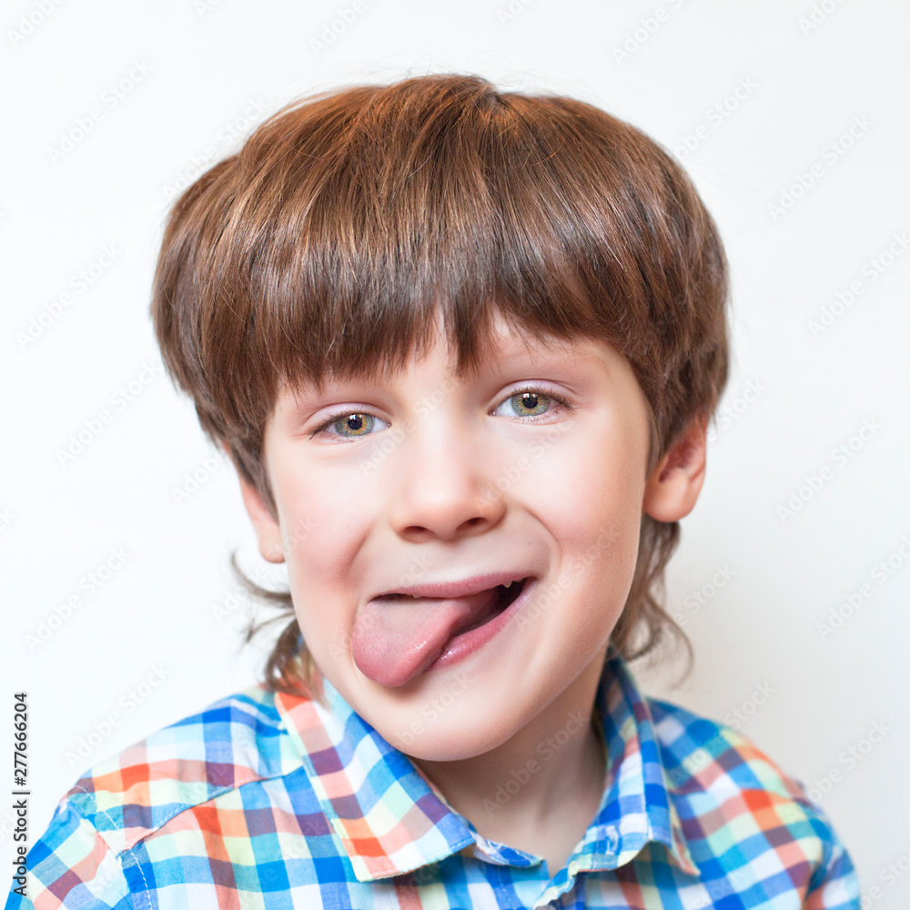 A smiling child with a tongue sticking out A smiling child with a tongue sticking out