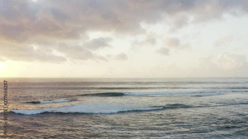 Calm ocean in the morning, beautiful waves are running at Sanur beach, Bali, Indonesia Calm ocean in the morning, beautiful waves are running at Sanur beach, Bali, Indonesia