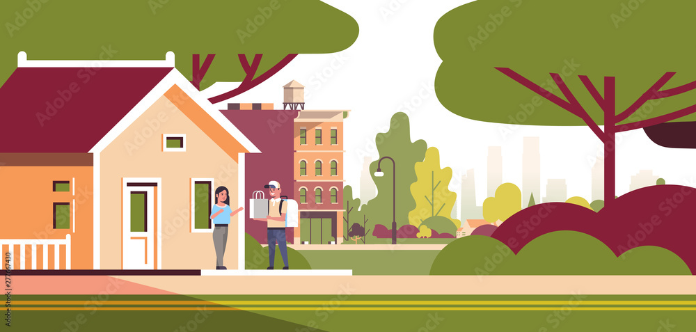 woman receiving order from man courier in cap with backpack and paper package express food delivery from shop or restaurant concept modern house building exterior flat horizontal full length
