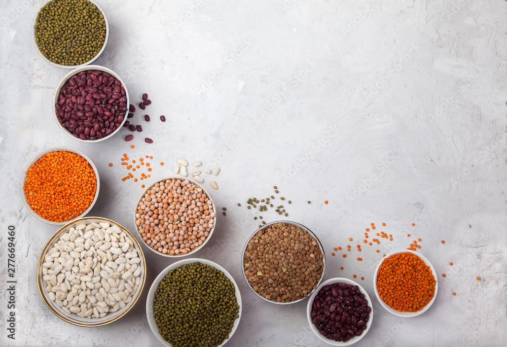 Red and white beans, green and red lentils, sunflower and pumpkin in cups on a white background. superfood Red and white beans, green and red lentils, sunflower and pumpkin in cups on a white background. superfood