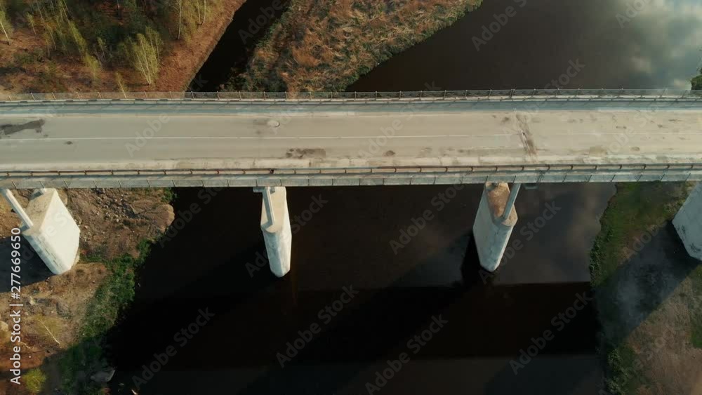 Aerial top view of car traffic on the bridge across the river. Aerial top view of car traffic on the bridge across the river.