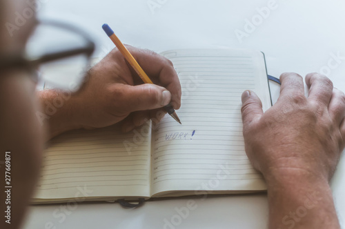 a person makes an entry in a notebook for doing business