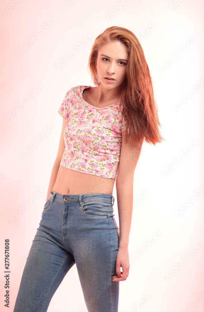 modern girl in jeans posing in front of the camera. Stock Photo | Adobe  Stock