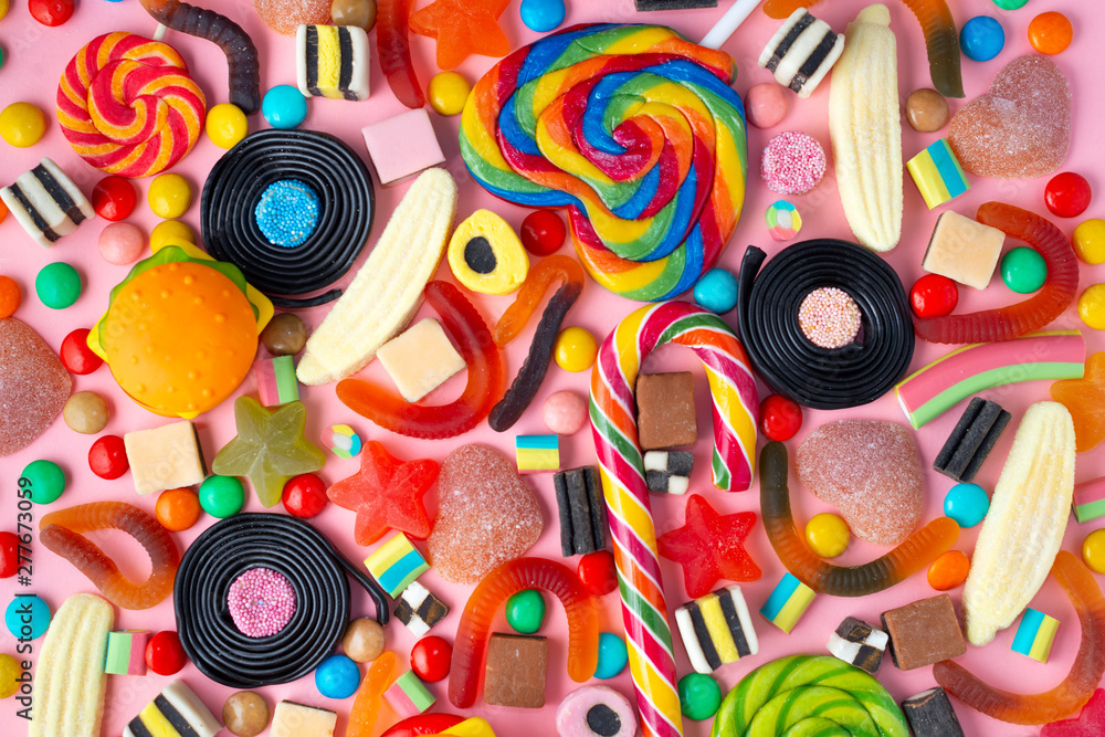 background of lollipops and candies on pink
