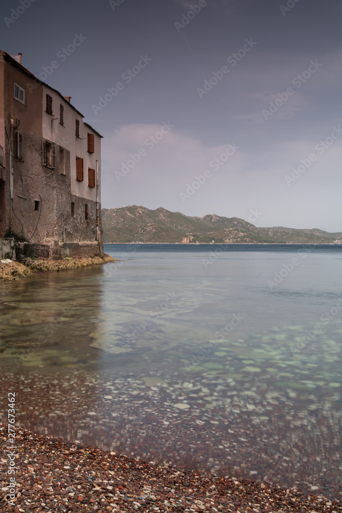 Houses built near the water, in the village of Saint Florent, Corsica