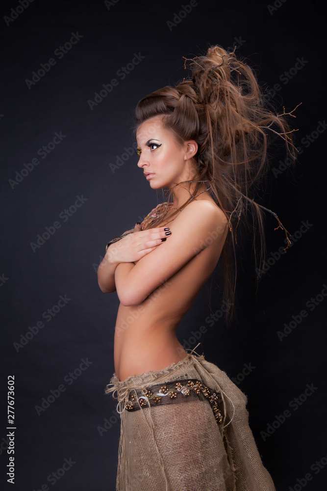 Naklejka premium Young beautiful nude woman in the image of a tree.