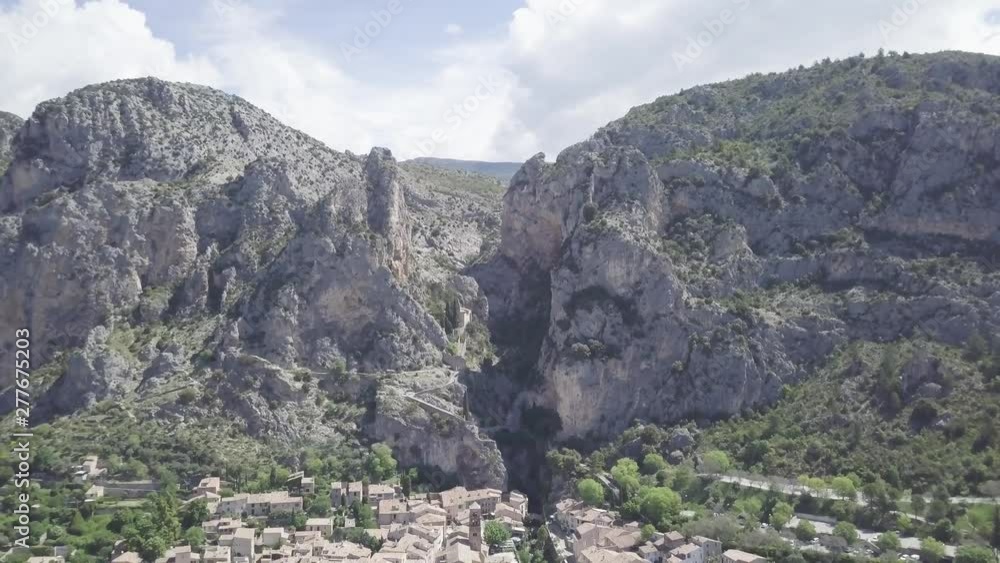 Aerial dolly out view of Notre Dame ravine and village of Moustiers Sainte Marie, France. Aerial dolly out view of Notre Dame ravine and village of Moustiers Sainte Marie, France.