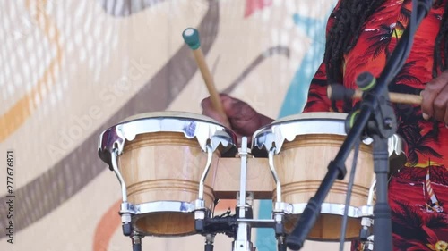 A drummer plays on stage at a music festival