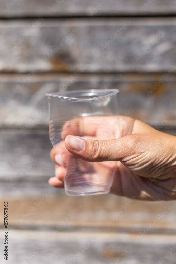 compressed plastic glass in hand compressed plastic glass in hand