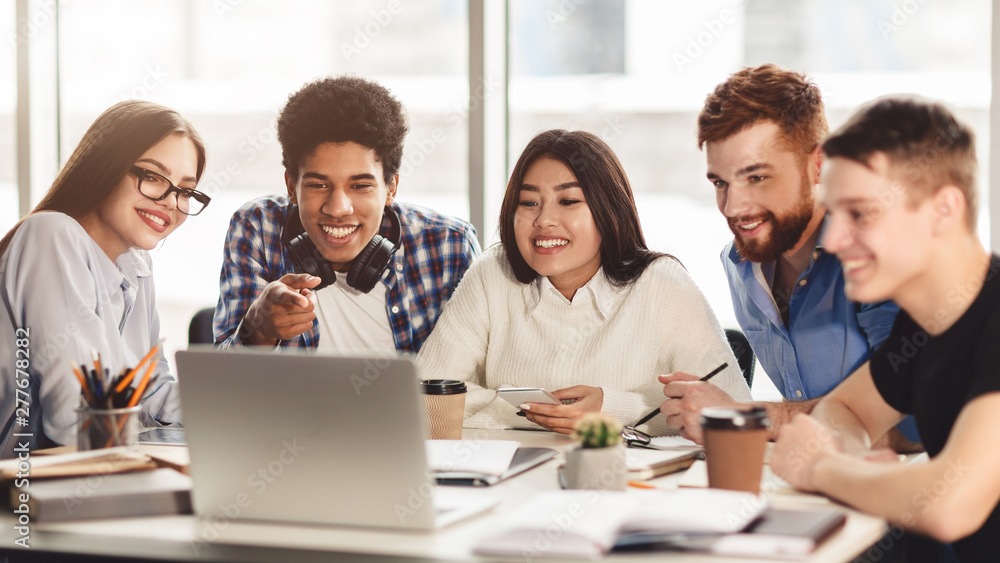 Group of multiracial students preparing for exams with laptop