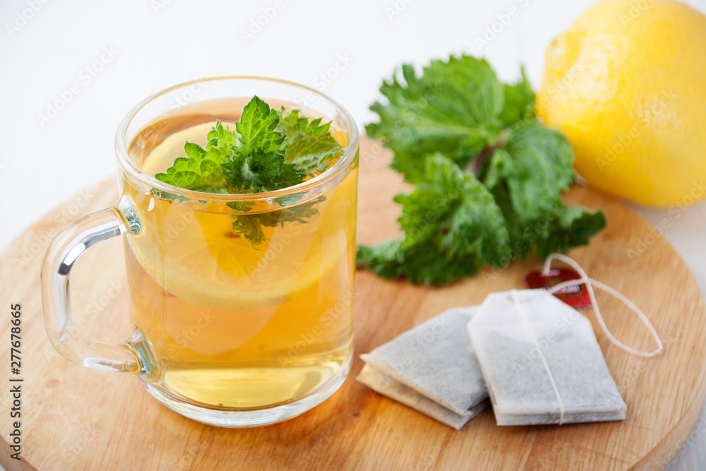 Green tea with mint and lemon in a glass mug Green tea with mint and lemon in a glass mug