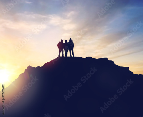 travel, tourism and hike concept - group of travelers with backpacks on mountain top over sunrise background