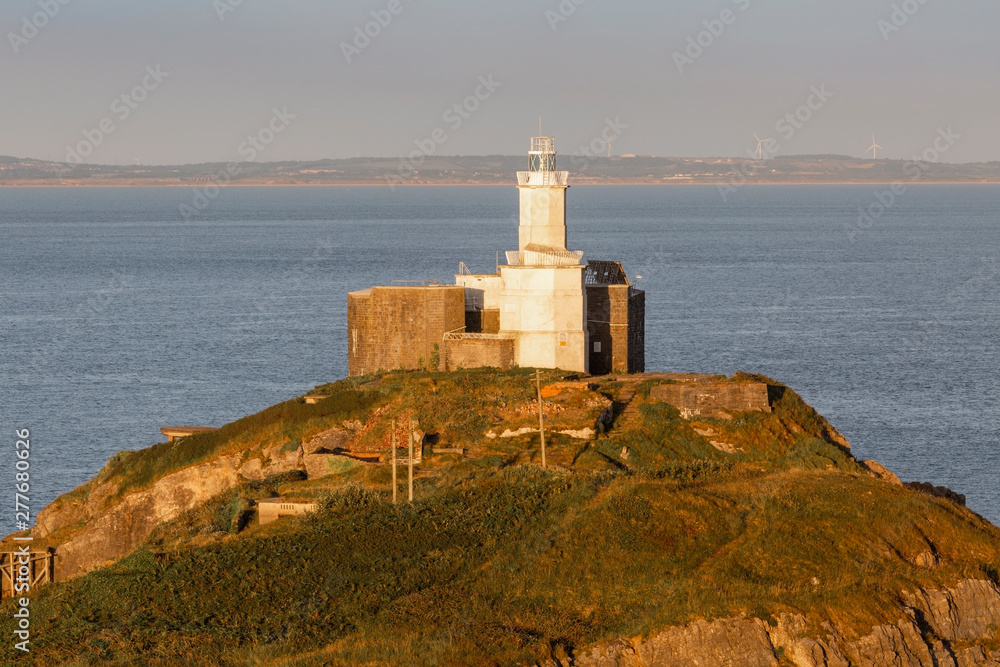 Mumbles Lighthouse The iconic landmark that is Mumbles Lighthouse on the Gower peninsula in Swansea, South Wales, UK.