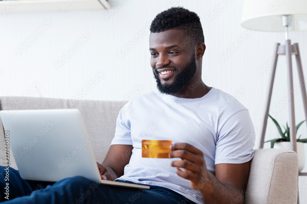 Man purchasing product online, using credit card to pay Man purchasing product online, using credit card to pay