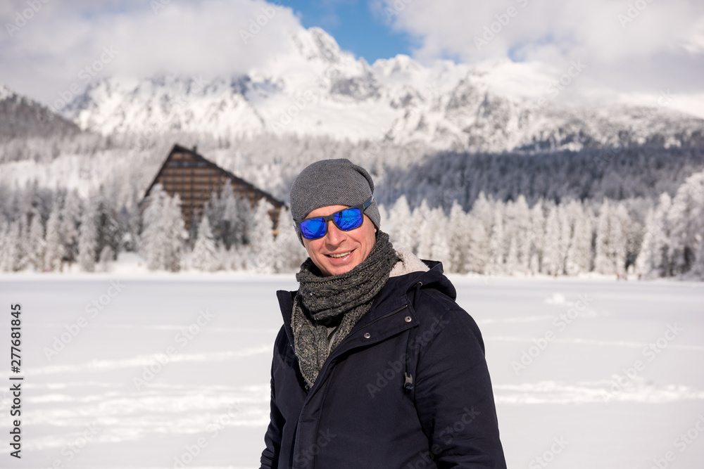 Portrait of young man in winter mountains