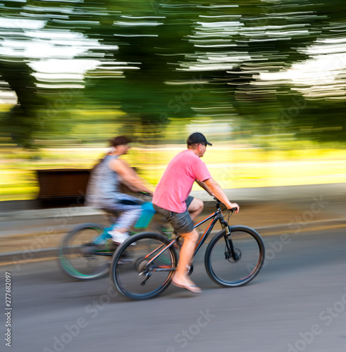 Two cyclists on the city roadway in motion blur