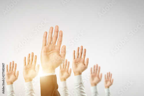 Businessmen raised their hands to win the celebration of the organization.The concept of business is geared towards success,sunlight effect.