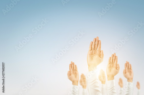 Businessmen raised their hands to win the celebration of the organization.The concept of business is geared towards success,sunlight effect.