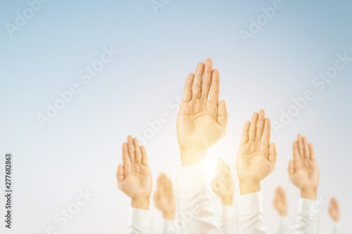 Businessmen raised their hands to win the celebration of the organization.The concept of business is geared towards success,sunlight effect.