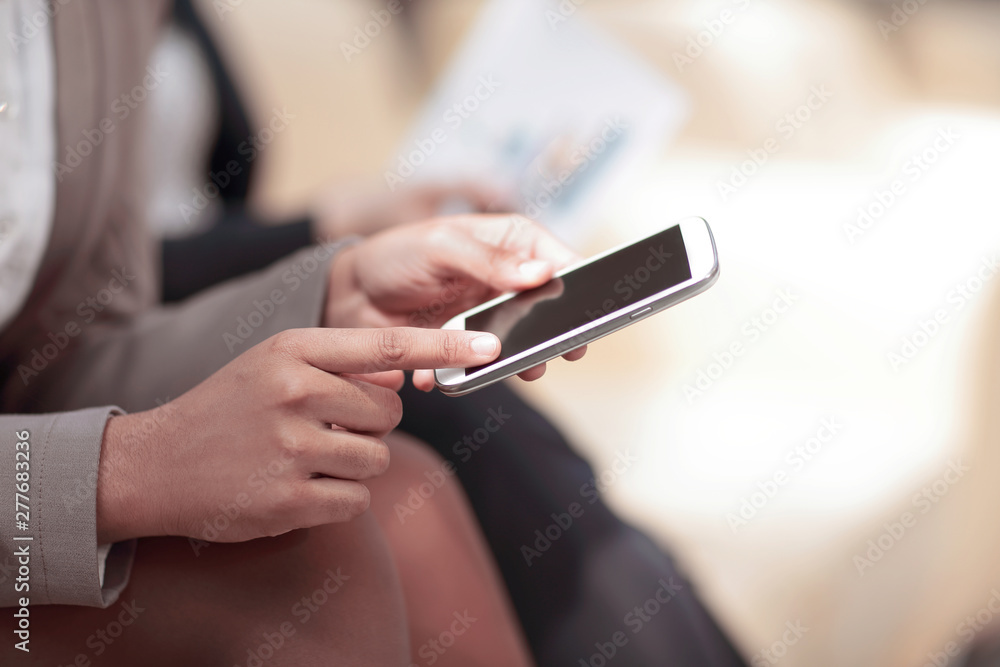 close up.business woman presses the screen of the smartphone close up.business woman presses the screen of the smartphone