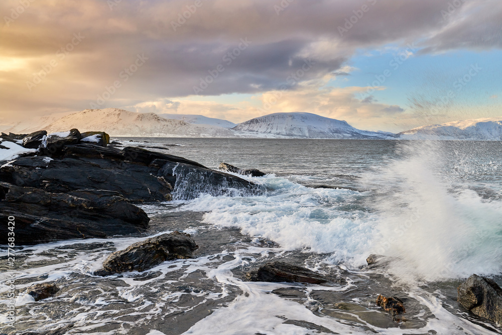 waves crashing on rocks, winter storm in norway, lyngen