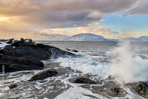 waves crashing on rocks  winter storm in norway  lyngen