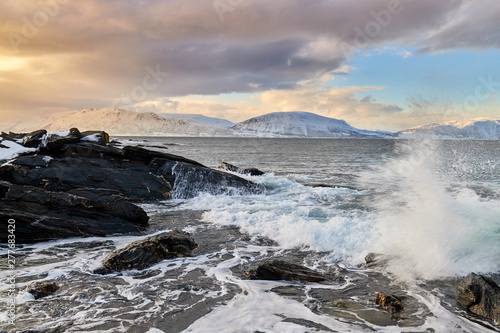 waves crashing on rocks, winter storm in norway, lyngen