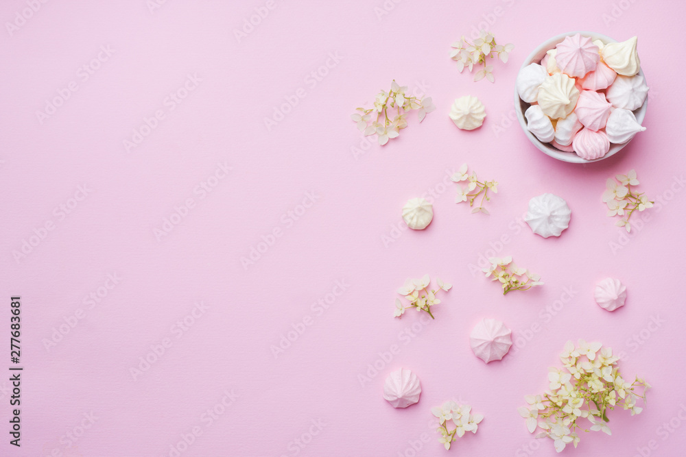 Colored small meringues on a pink background. Flat lay concept. Copy space. - obrazy, fototapety, plakaty 