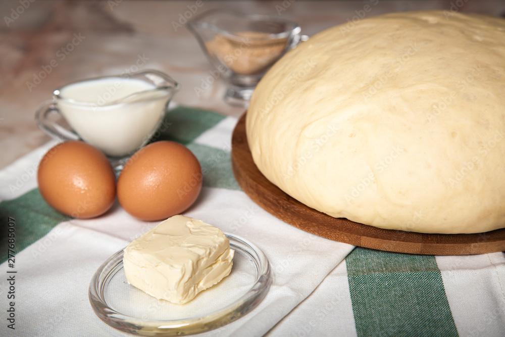 Bakery ingredients. On the table are flour, eggs and pastry dough Bakery ingredients. On the table are flour, eggs and pastry dough