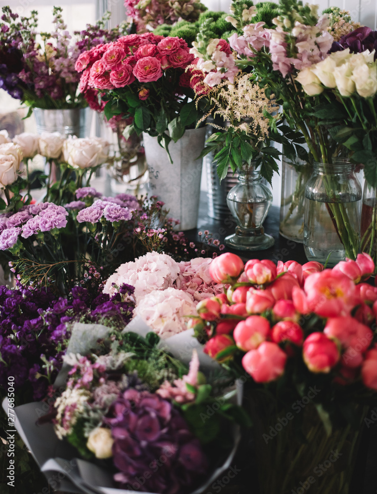 Fresh flowers at the florist shop fridge: hydrangeas, peonies, matthiolas, roses, carnations, eucalyptus