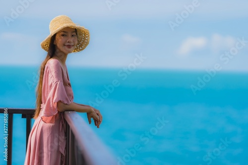 Portrait beautiful young asian woman looking sea beach ocean for relax in holiday vacation travel