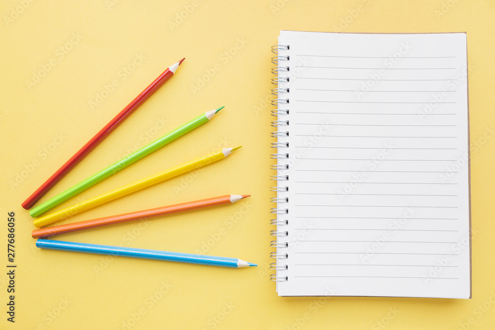 Bright pencils near notepad Bright pencils near notepad