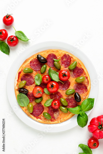 Pizza with salami and olives, top down view