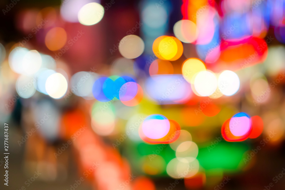 Blurred of car on road in the city at Night time. Defocused of traffic jams have car, bu and motorcycle. Red, Orange, Yellow, White and Blue bokeh light. Blur of light glitter. Glow texture background