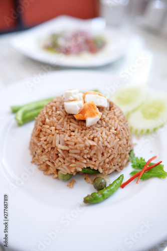 Thai shrimp paste fried rice topping with egg yolk and eat with fresh vegetable ,Thai cuisine