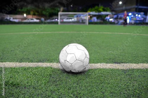 White Soccer field grass with ball at kick off point. © lmanju