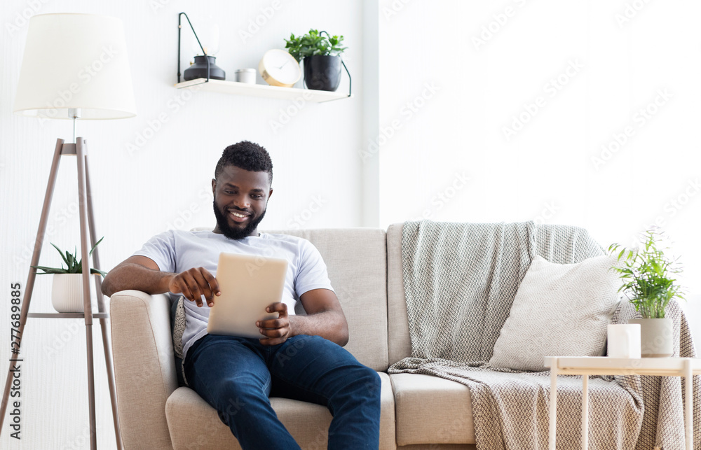 African american man watching movie on tablet indoors African american man watching movie on tablet indoors