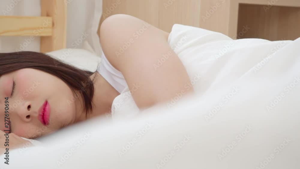 Asian woman dreaming while sleeping on bed in bedroom, Beautiful japanese female using relax time lying on bed at home. Lifestyle women using relax time at home concept. Asian woman dreaming while sleeping on bed in bedroom, Beautiful japanese female using relax time lying on bed at home. Lifestyle women using relax time at home concept.