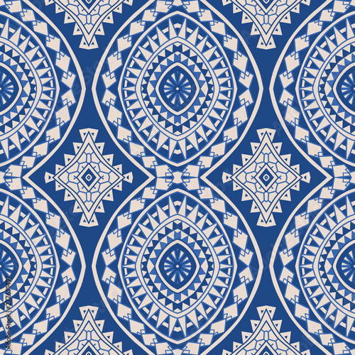 Vector abstract seamless pattern from indigo blue and light beige geometrical shapes, rhombus, triangles, Maori ornaments, wavy stripes. Textile print. Wrapping paper, wallpaper, Batik paint