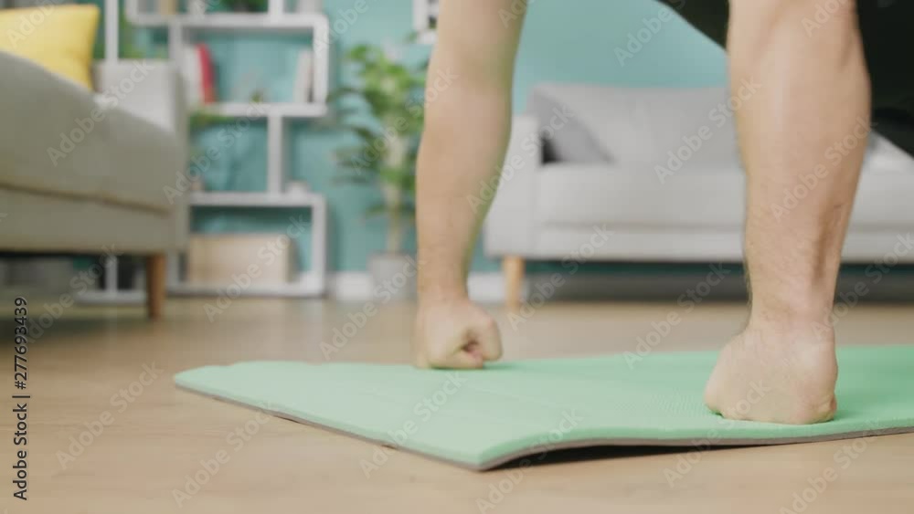 young man is doing exercises on floor of modern apartment young man is doing exercises on floor of modern apartment