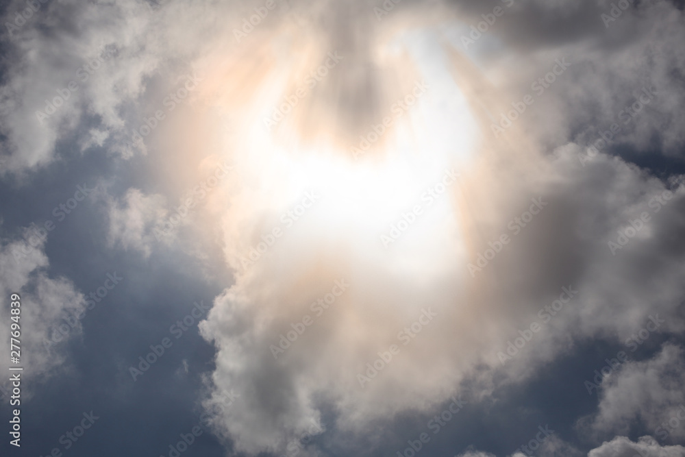 clouds and sun ray with blue sky on the background and copy space for your text