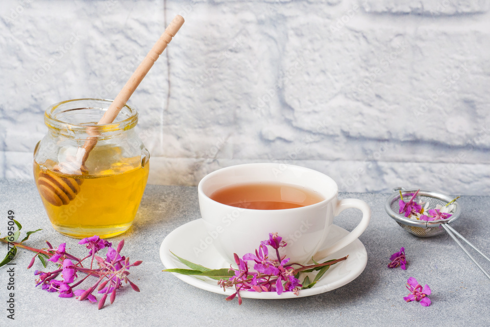 Useful herbal tea from fermented leaves fireweed on grey background. Traditional Russian Koporye Tea Ivan Chai Copy space. Useful herbal tea from fermented leaves fireweed on grey background. Traditional Russian Koporye Tea Ivan Chai Copy space.